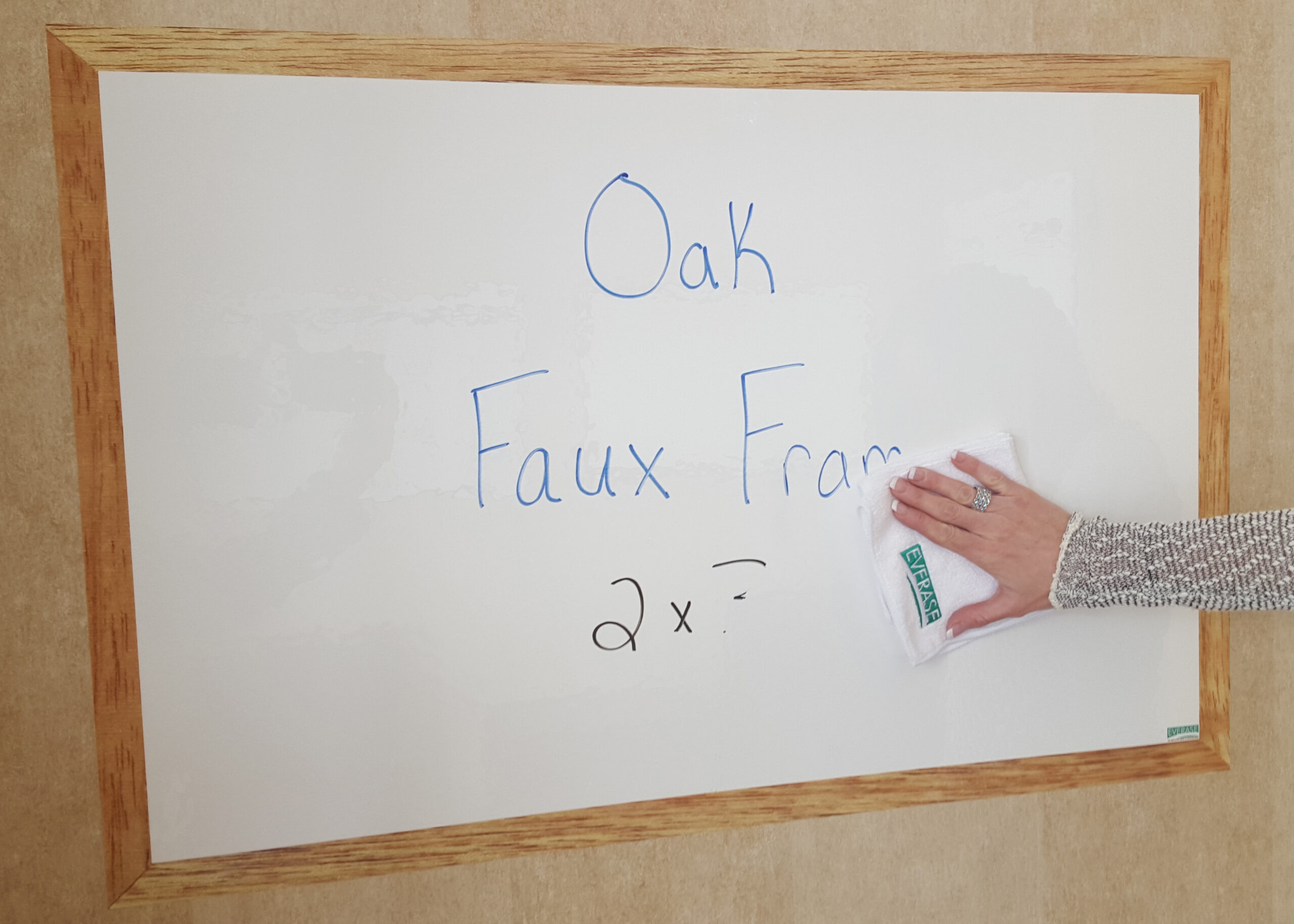 dry erase stick-on surface with faux oak frame; easy to clean