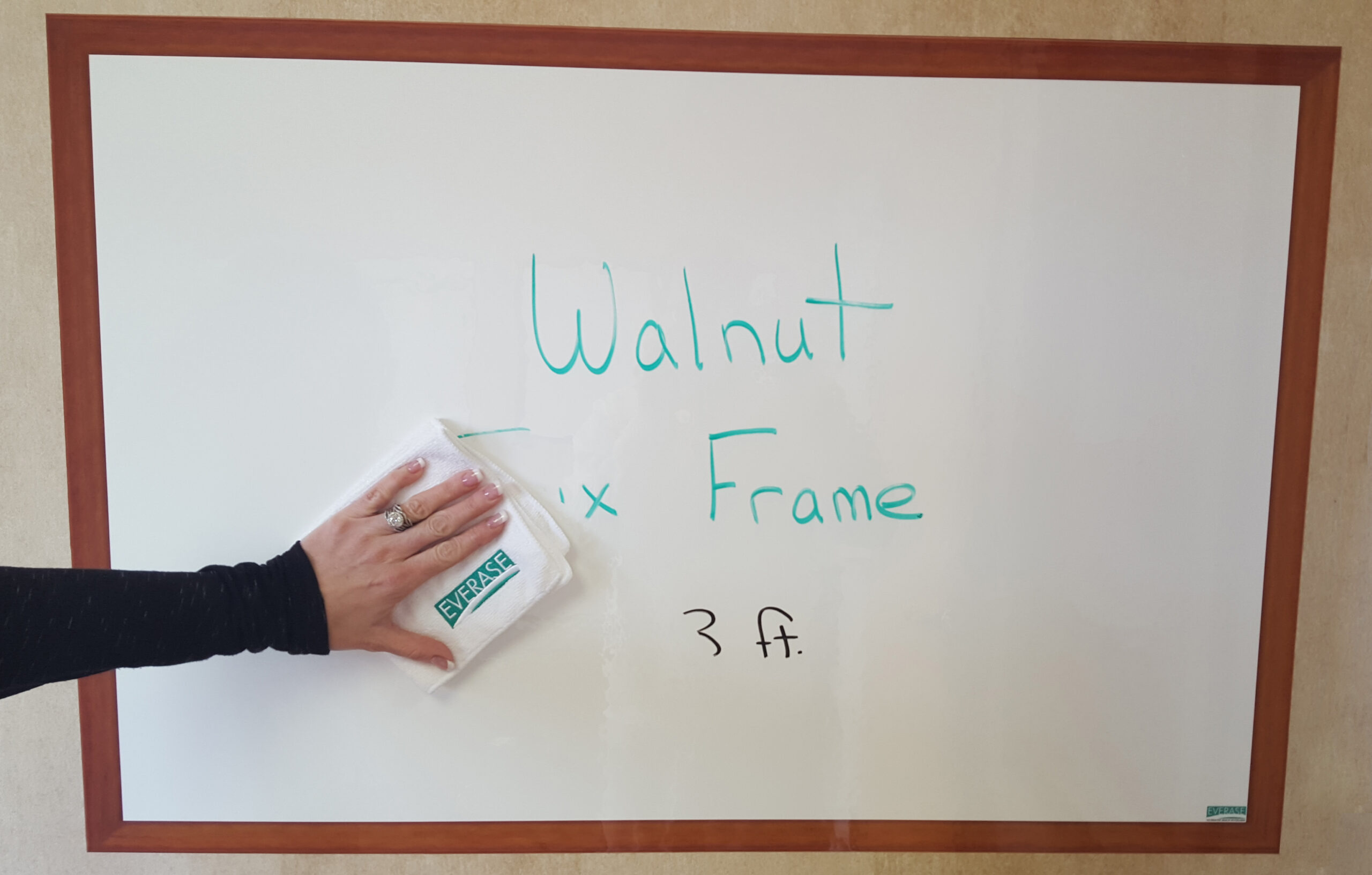 dry erase stick-on surface with faux walnut frame; easy to clean