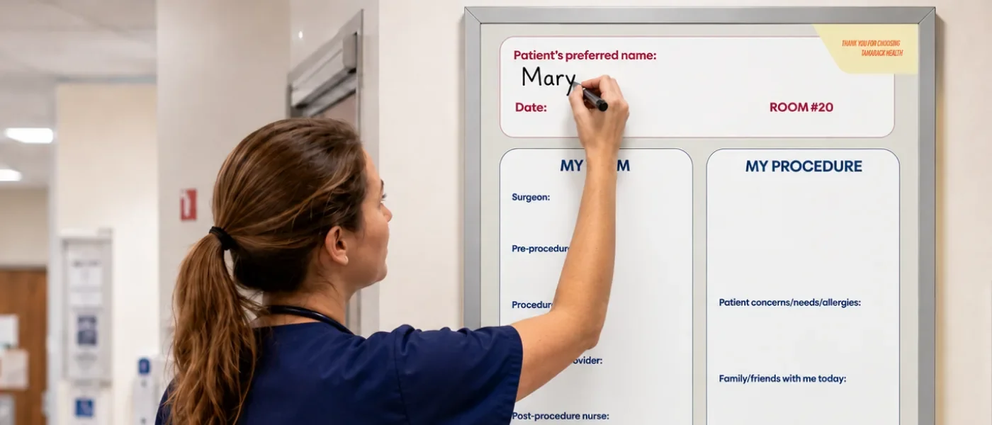 Nurse writing on a custom printed patient room whiteboard